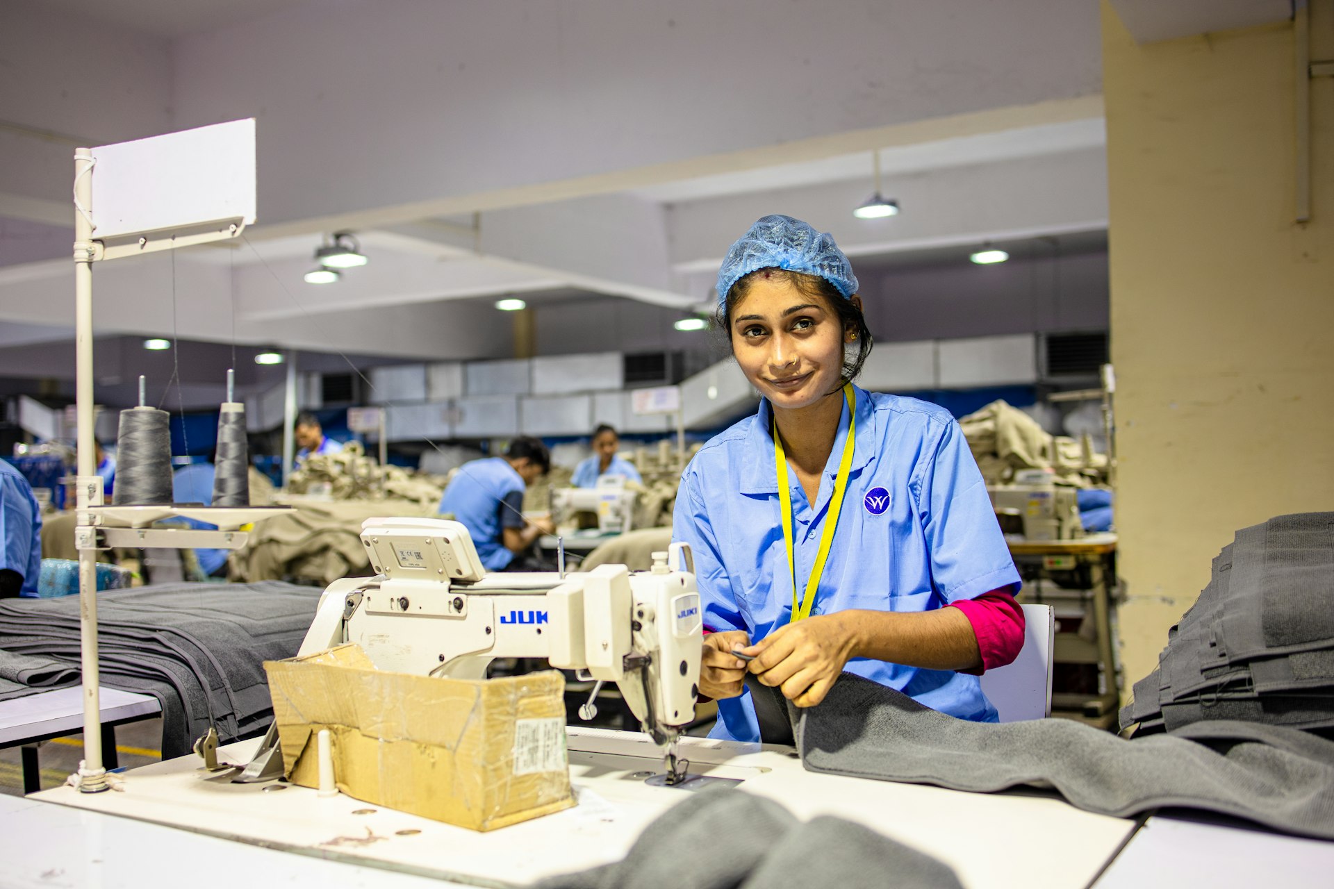 Quality analyst inspecting fabric before it is cut for bag panels