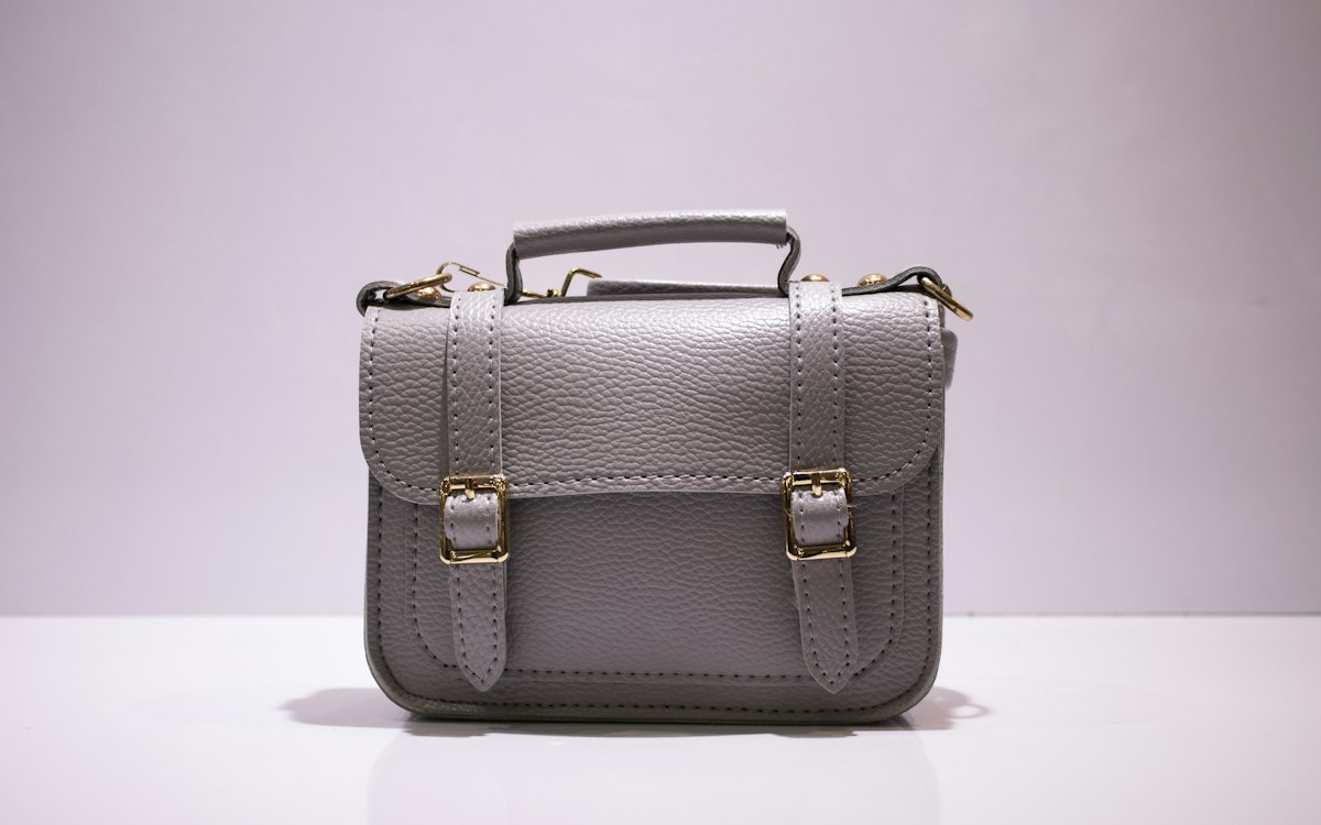 Structured office satchel with metal buckles