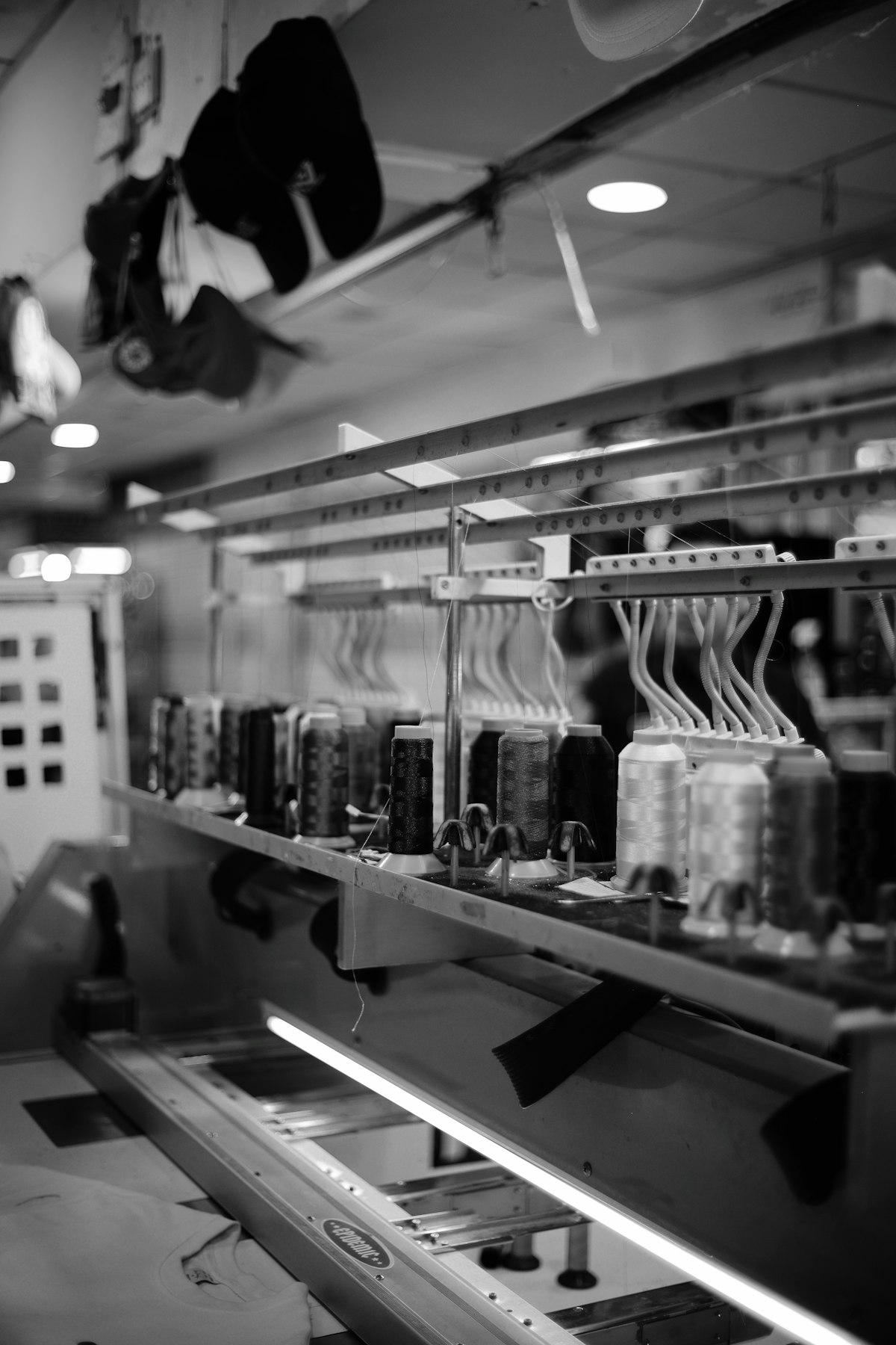 Multi-head industrial embroidery machine running a customer logo