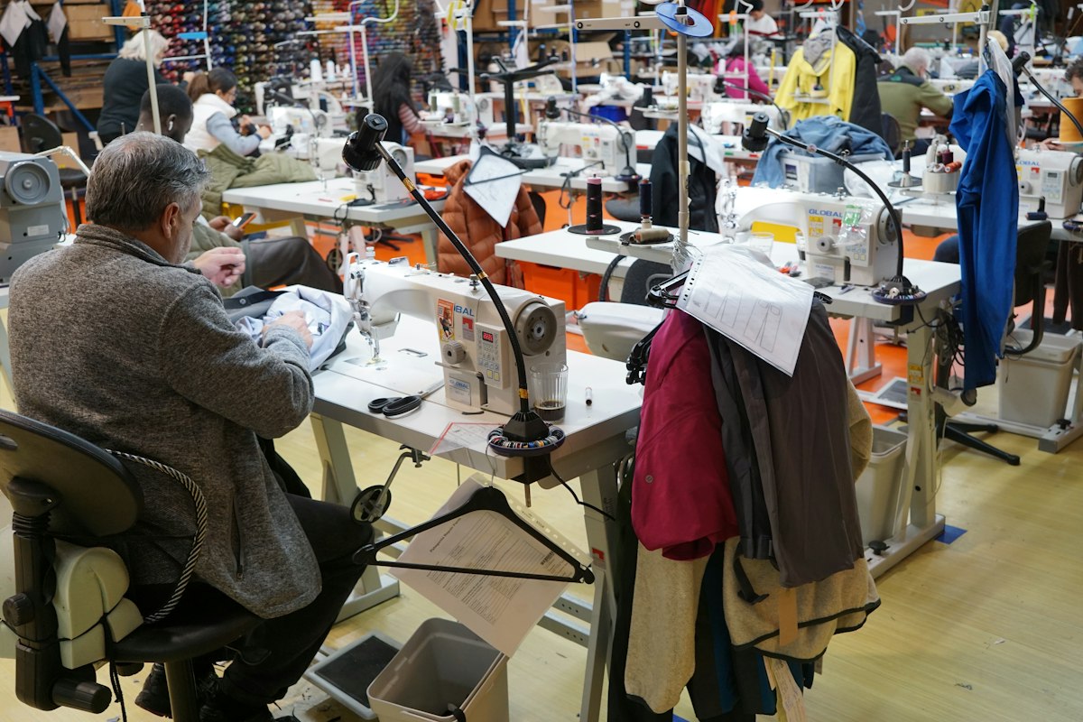 Operator stitching a bag panel on an industrial machine